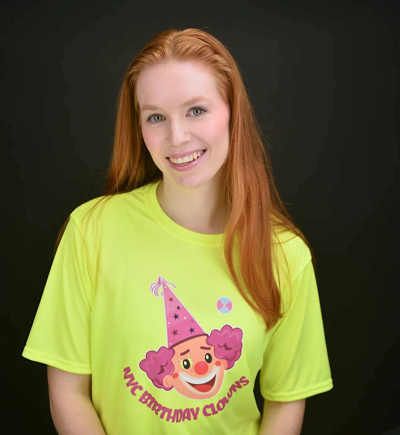 Friendly NYC Birthday Clowns entertainer Anna wearing the bright yellow branded shirt our team wears