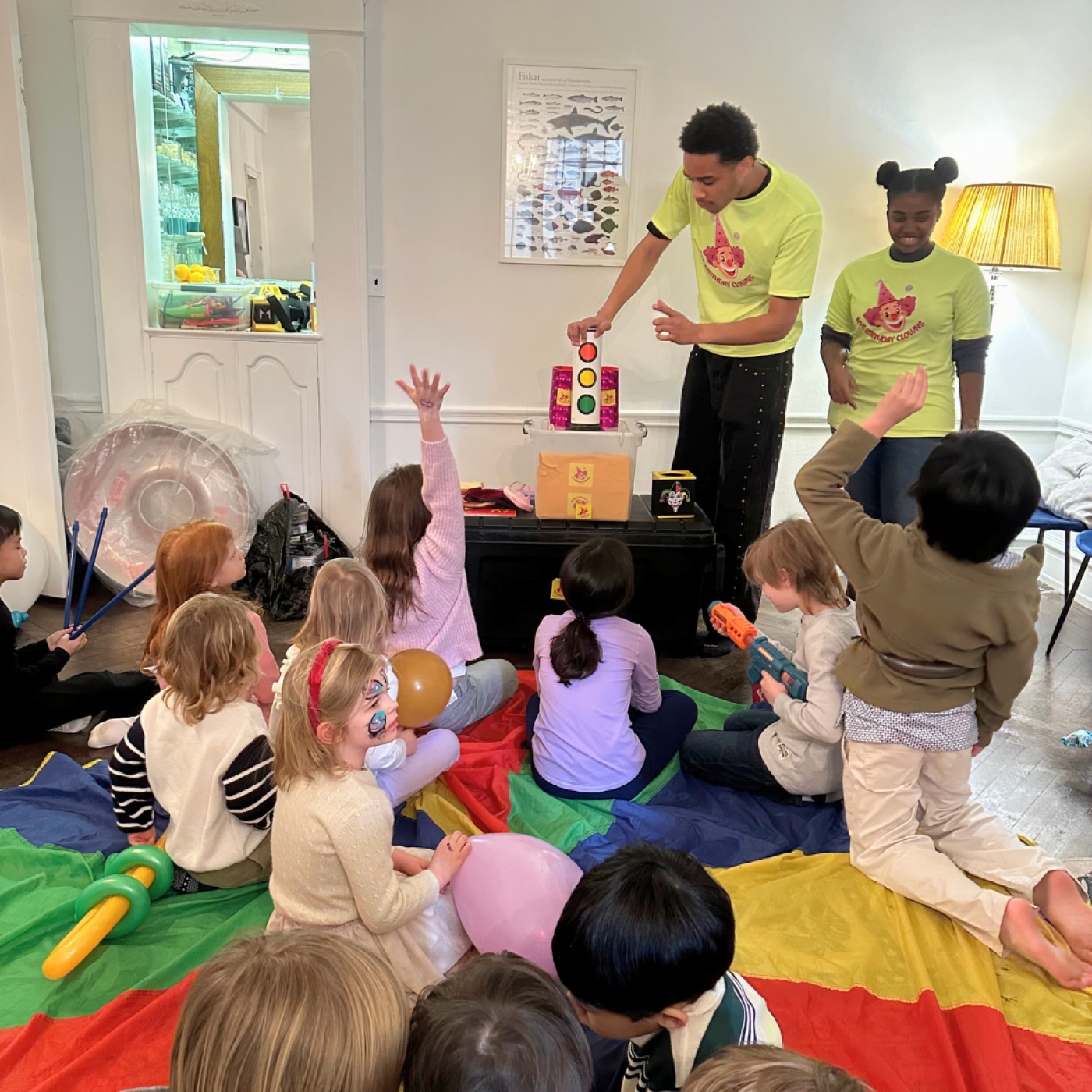 Two NYC Birthday Clowns entertainers leading an activity at a real home birthday party